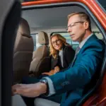 Business traveler boarding a chauffeured sedan in downtown San Francisco