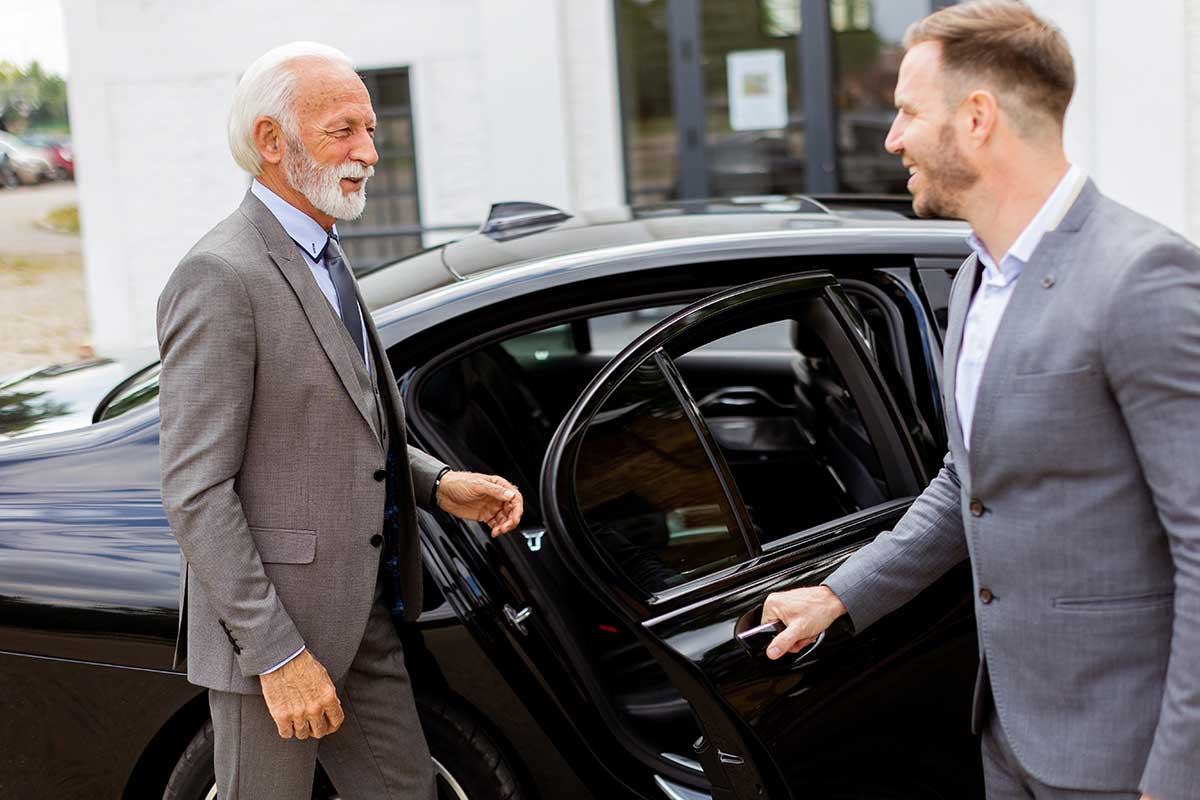 meet-client Limo Classic chauffeur greeting a client